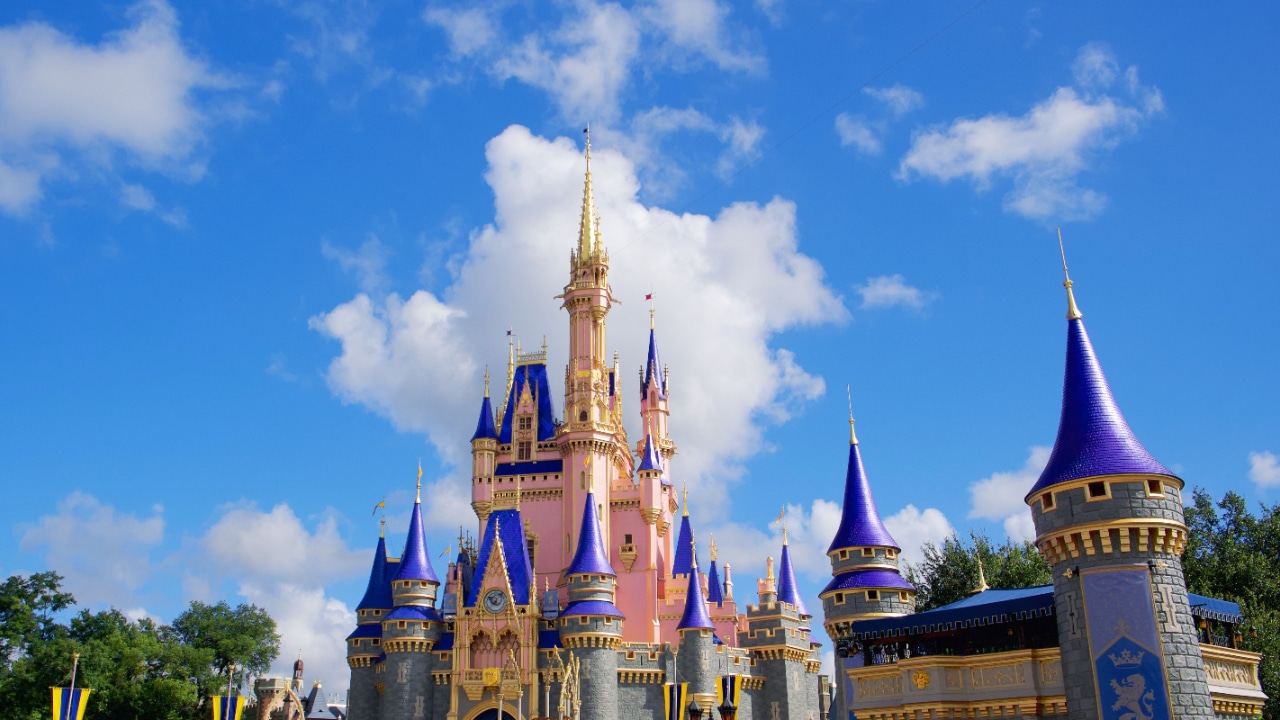 Disney's Cinderella castle with blue turrets and a blue sky, fit for a princess.