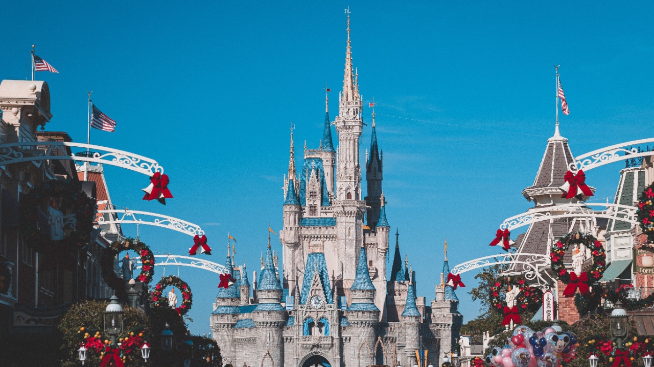 Cinderella castle adorned with festive Christmas decorations at Walt Disney World.