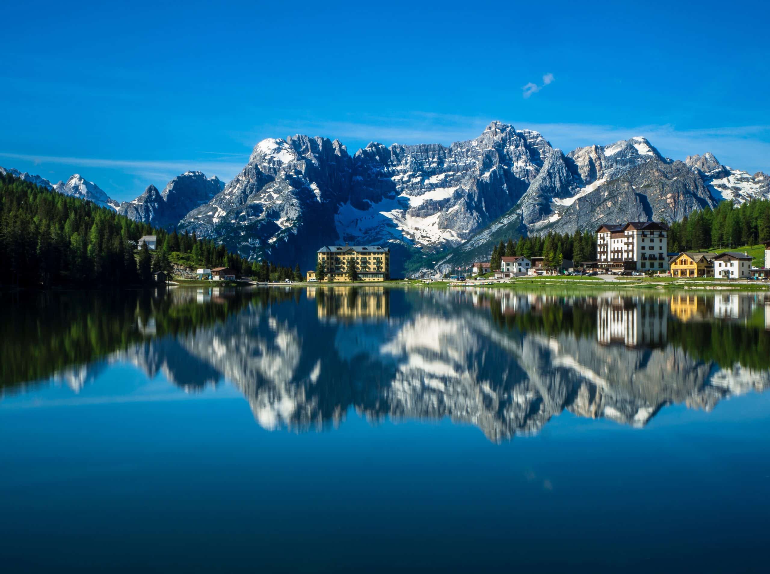 A lake with mountains reflected in it.