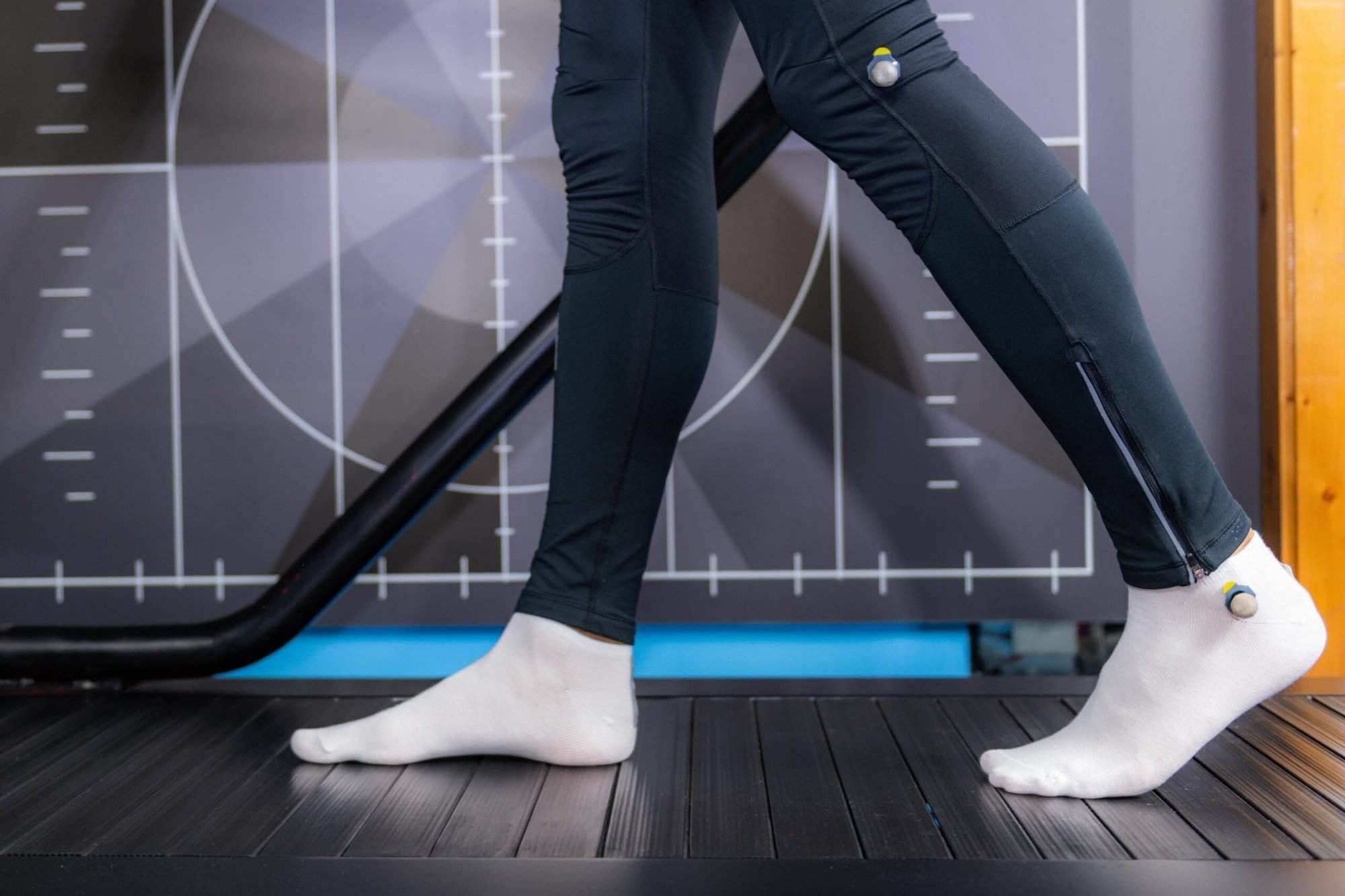 A runner's feet undergoing gait analysis while testing on a treadmill.